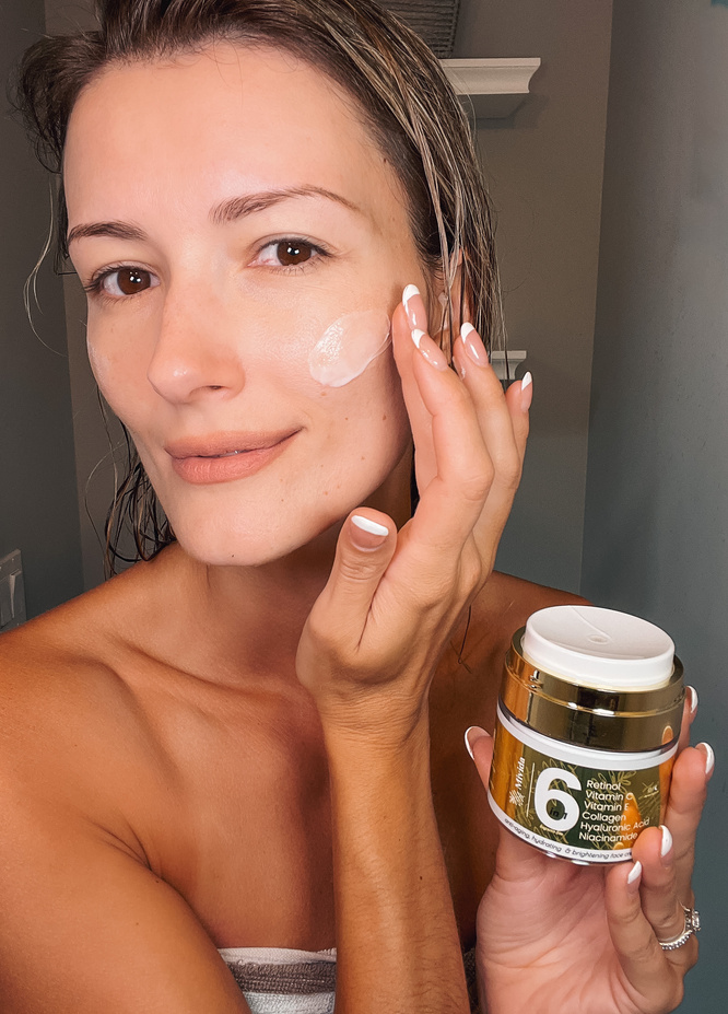 ugc creator applying face lotion to her face